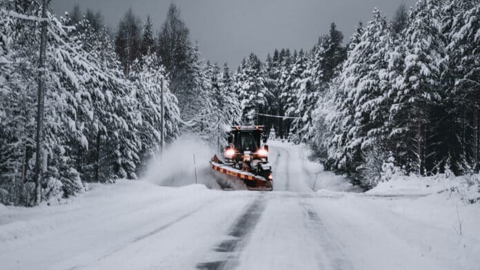Tractor keeping a winter road clear.