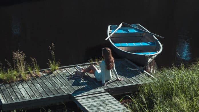 Lisah Silfwer summer vibing beside a row boat.