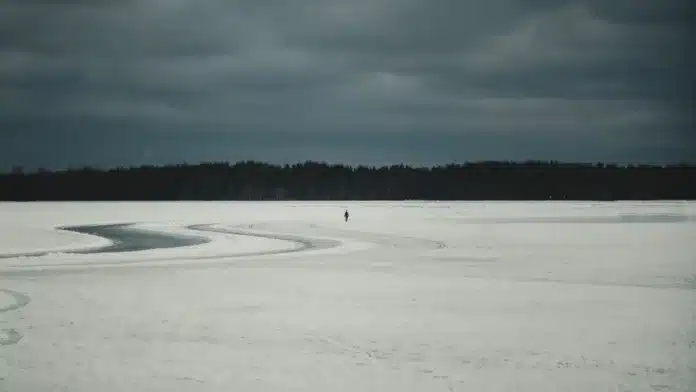 Woman Walking on Frozen Lake