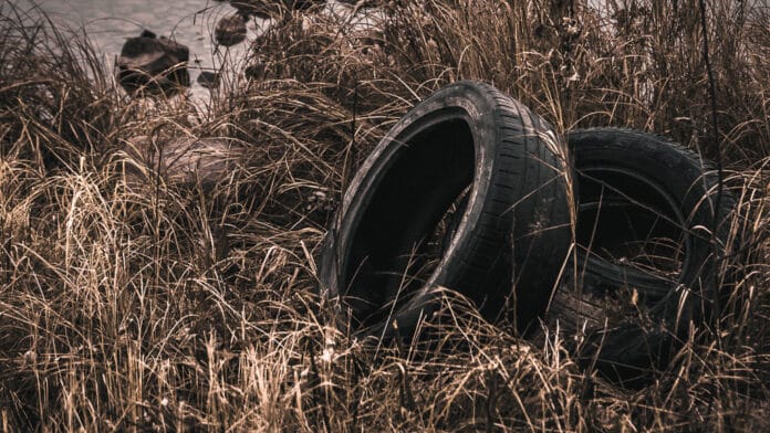 Abandoned Tires in Brown Grass